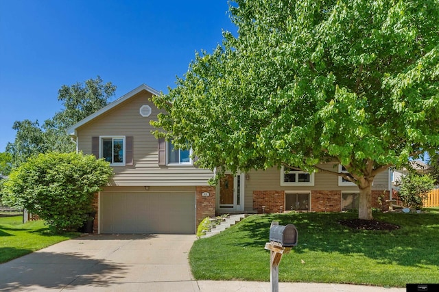 918 N 150th St, Omaha, NE 68154 - view of front of home featuring brick siding, an attached garage, concrete driveway, and a front yard