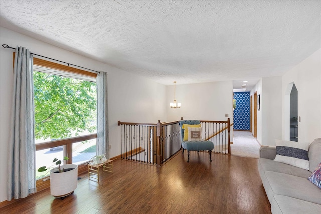 918 N 150th St, Omaha, NE 68154 - living area featuring wood finished floors, plenty of natural light, a chandelier, a textured ceiling, and arched walkways