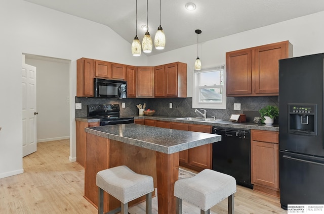 209 S Vine St, Mead, NE 68041 - kitchen featuring black appliances, a sink, backsplash, dark countertops, and light wood finished floors