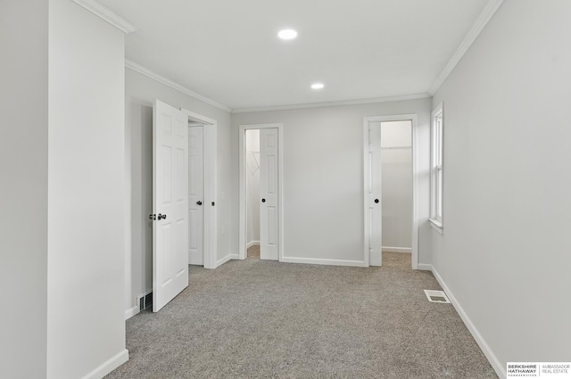 209 S Vine St, Mead, NE 68041 - unfurnished bedroom featuring ornamental molding, carpet flooring, baseboards, recessed lighting, and a walk in closet