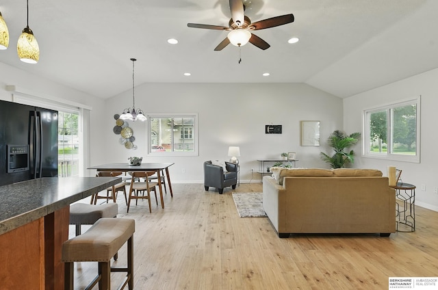 209 S Vine St, Mead, NE 68041 - living room featuring lofted ceiling, light wood-style floors, a ceiling fan, baseboards, and a chandelier