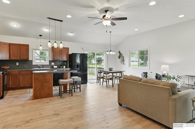 209 S Vine St, Mead, NE 68041 - living area with lofted ceiling, a ceiling fan, light wood-type flooring, recessed lighting, and a chandelier
