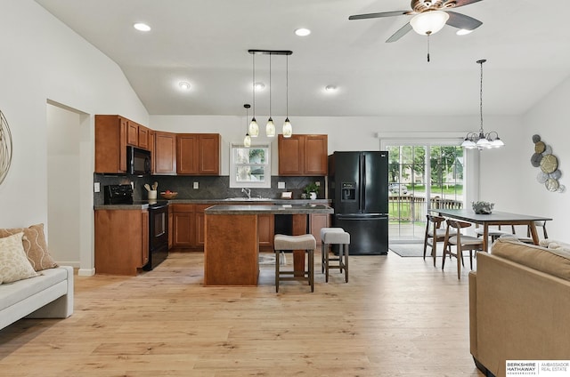 209 S Vine St, Mead, NE 68041 - kitchen with black appliances, a sink, open floor plan, a center island, and dark countertops