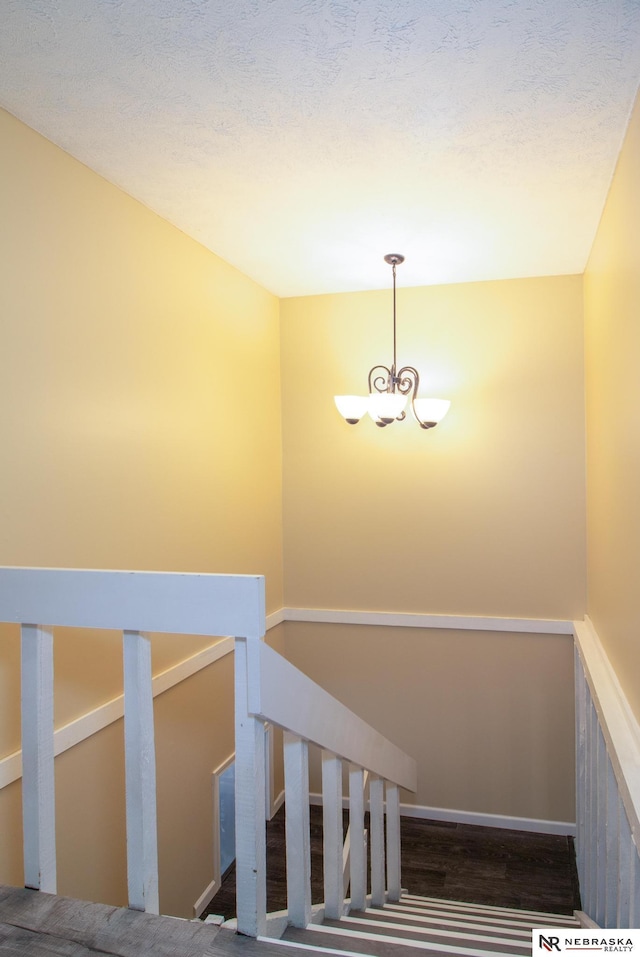 13220 Carpenter St, Omaha, NE 68138 - stairway featuring a chandelier and wood finished floors
