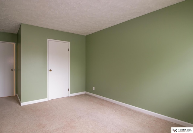 13220 Carpenter St, Omaha, NE 68138 - unfurnished bedroom featuring light colored carpet, a textured ceiling, and baseboards