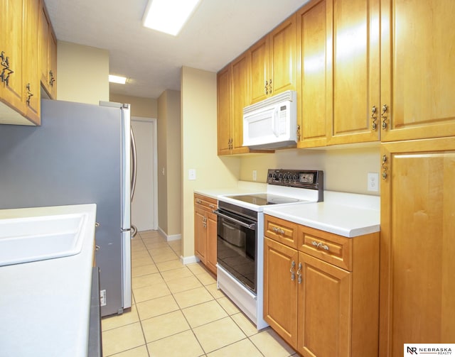 13220 Carpenter St, Omaha, NE 68138 - kitchen featuring white appliances, light tile patterned floors, and light countertops