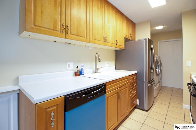 13220 Carpenter St, Omaha, NE 68138 - kitchen with dishwashing machine, washer and clothes dryer, a sink, light tile patterned floors, and light countertops