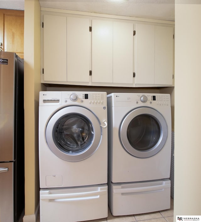 13220 Carpenter St, Omaha, NE 68138 - laundry room with washer and clothes dryer and light tile patterned flooring