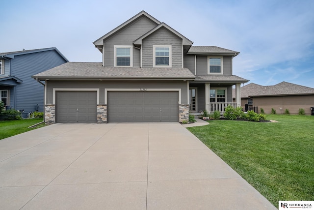 21313 Castlerock Ln, Gretna, NE 68028 - view of front facade featuring a porch, a front lawn, concrete driveway, roof with shingles, and stone siding