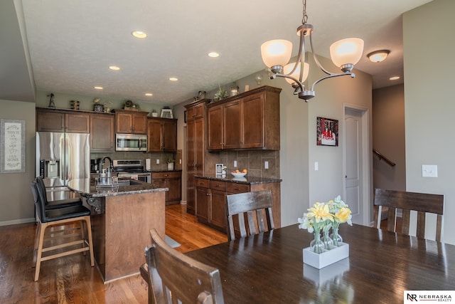 21313 Castlerock Ln, Gretna, NE 68028 - dining space featuring wood finished floors, a chandelier, and recessed lighting