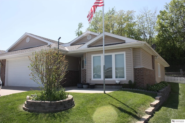 120 W Deer Ln, Plattsmouth, NE 68048 - view of front of property featuring brick siding, a garage, driveway, and a shingled roof