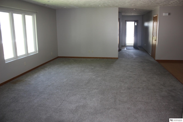 120 W Deer Ln, Plattsmouth, NE 68048 - carpeted empty room with a textured ceiling and baseboards