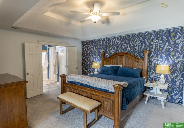 3902 Fox Ridge Dr, Bellevue, NE 68123 - bedroom with a tray ceiling, light colored carpet, and a ceiling fan