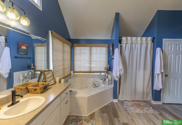 3902 Fox Ridge Dr, Bellevue, NE 68123 - bathroom featuring lofted ceiling, a bath, wood finished floors, vanity, and a shower