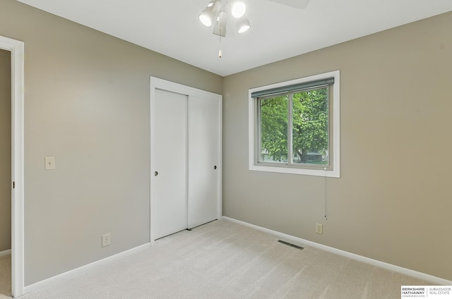 2615 Jack Pine St, Bellevue, NE 68123 - unfurnished bedroom featuring light carpet, baseboards, a closet, and a ceiling fan