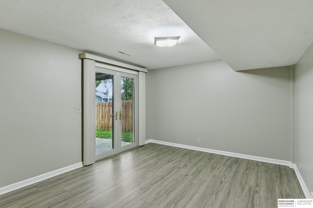 2615 Jack Pine St, Bellevue, NE 68123 - empty room with wood finished floors, baseboards, and a textured ceiling