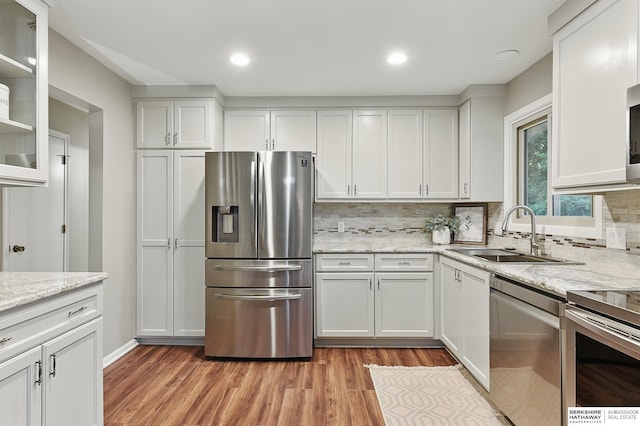 2615 Jack Pine St, Bellevue, NE 68123 - kitchen featuring appliances with stainless steel finishes, a sink, white cabinets, decorative backsplash, and recessed lighting