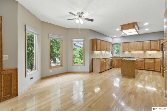 10428 Monroe St, Omaha, NE 68127 - kitchen with appliances with stainless steel finishes, a sink, a kitchen island, light wood-style flooring, and recessed lighting