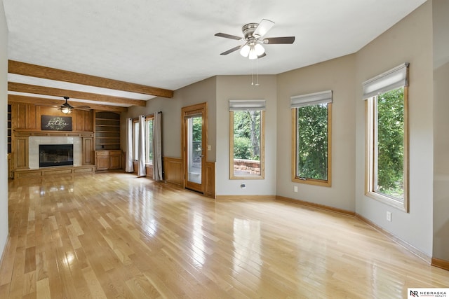 10428 Monroe St, Omaha, NE 68127 - unfurnished living room with ceiling fan, beam ceiling, light wood-style floors, a premium fireplace, and baseboards