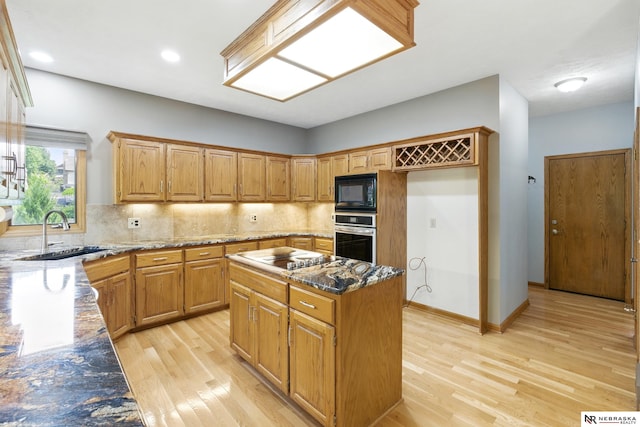 10428 Monroe St, Omaha, NE 68127 - kitchen with stainless steel oven, electric cooktop, a sink, light wood finished floors, and black microwave
