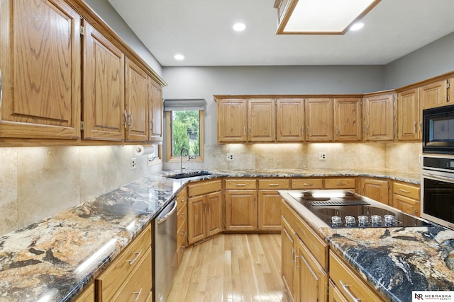 10428 Monroe St, Omaha, NE 68127 - kitchen featuring black appliances, light wood finished floors, a sink, recessed lighting, and decorative backsplash