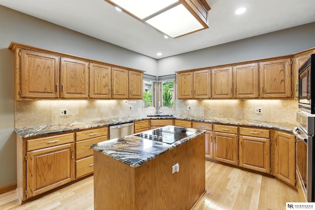 10428 Monroe St, Omaha, NE 68127 - kitchen with light wood-style flooring, appliances with stainless steel finishes, dark stone counters, and recessed lighting