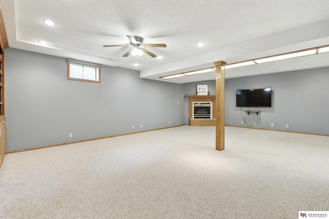 10428 Monroe St, Omaha, NE 68127 - basement with a fireplace with raised hearth, carpet, baseboards, recessed lighting, and a textured ceiling