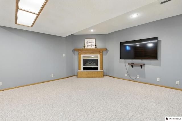 10428 Monroe St, Omaha, NE 68127 - unfurnished living room with carpet, baseboards, a glass covered fireplace, and recessed lighting