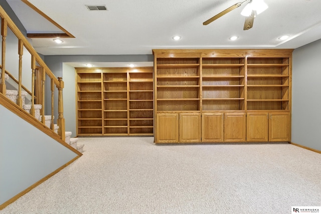 10428 Monroe St, Omaha, NE 68127 - basement with recessed lighting, light carpet, a ceiling fan, stairs, and baseboards