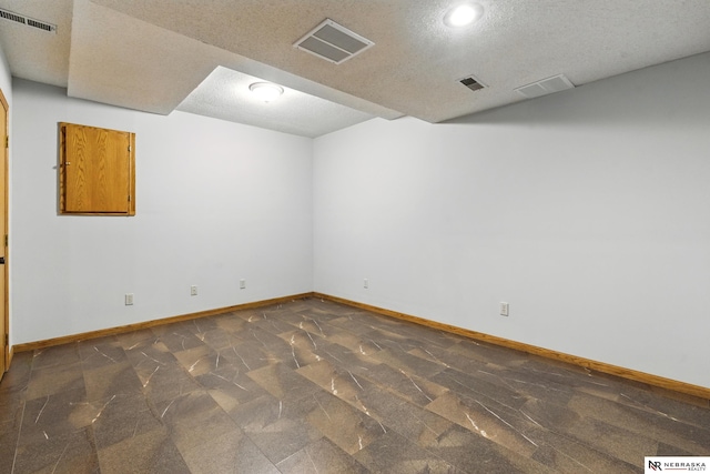 10428 Monroe St, Omaha, NE 68127 - spare room with baseboards, a textured ceiling, and recessed lighting