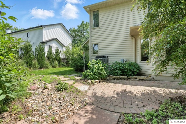 10428 Monroe St, Omaha, NE 68127 - view of yard featuring a patio and central AC