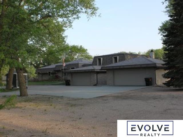 1599 S Main St Unit 7, Fremont, NE 68025 - view of front of home with driveway, a garage, and mansard roof