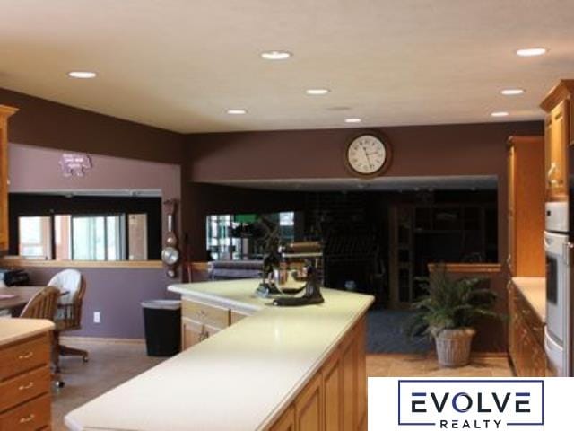 1599 S Main St Unit 7, Fremont, NE 68025 - kitchen featuring light countertops, recessed lighting, brown cabinets, and baseboards