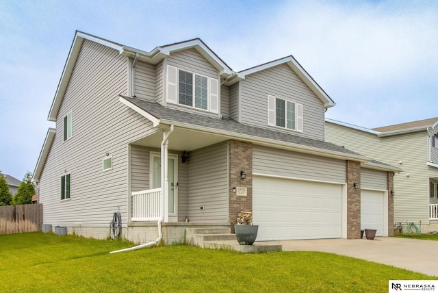 1715 Belford St, Lincoln, NE 68521 - view of front of home featuring a garage, driveway, brick siding, and central air condition unit