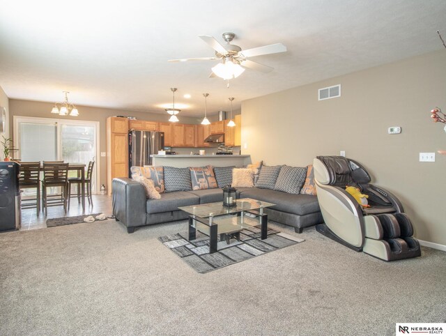 1715 Belford St, Lincoln, NE 68521 - living room with a ceiling fan, a chandelier, light colored carpet, and baseboards