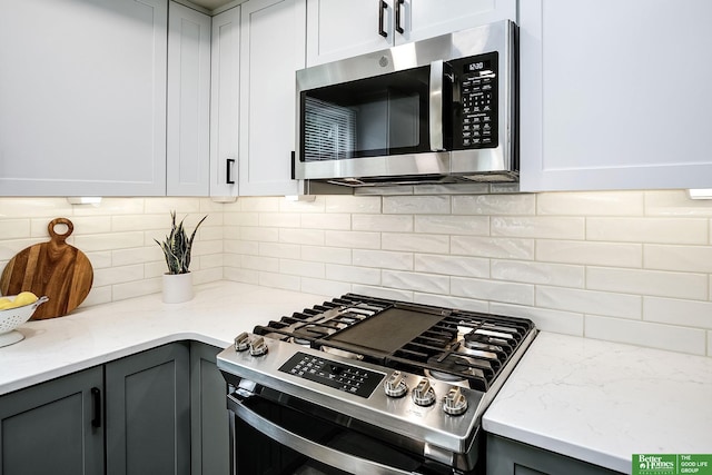 2833 S 107th St, Omaha, NE 68124 - kitchen featuring appliances with stainless steel finishes, gray cabinets, and backsplash
