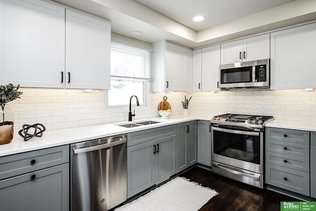 2833 S 107th St, Omaha, NE 68124 - kitchen featuring appliances with stainless steel finishes, gray cabinetry, a sink, and recessed lighting