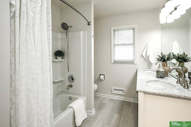 2833 S 107th St, Omaha, NE 68124 - full bath featuring wood finished floors, shower / bath combination with curtain, double vanity, baseboards, and toilet