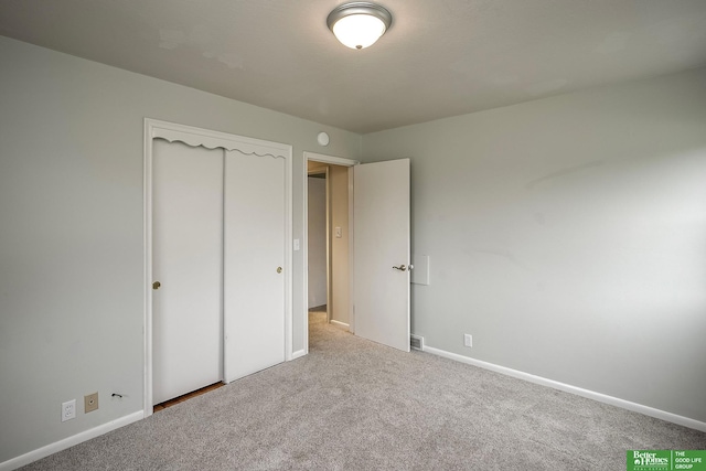 2833 S 107th St, Omaha, NE 68124 - unfurnished bedroom featuring carpet flooring, baseboards, and a closet