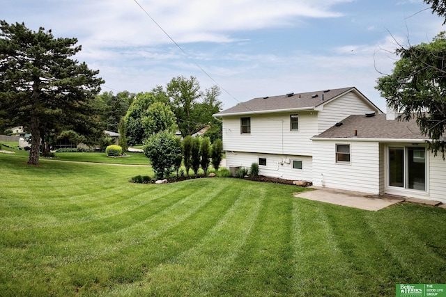 2833 S 107th St, Omaha, NE 68124 - back of property featuring a yard, a patio area, and a shingled roof