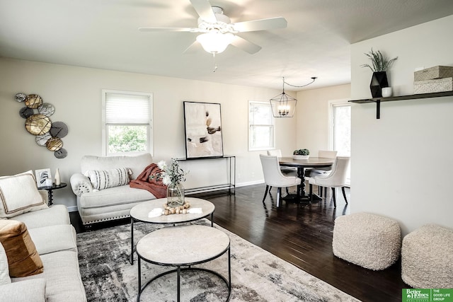 2833 S 107th St, Omaha, NE 68124 - living room featuring dark wood-style floors, healthy amount of natural light, ceiling fan, and baseboards