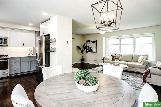 2833 S 107th St, Omaha, NE 68124 - dining area featuring dark wood finished floors, a chandelier, and recessed lighting