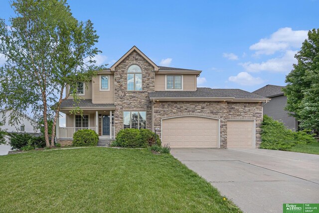 2231 Crystal Creek Dr, Papillion, NE 68046 - traditional-style house featuring stone siding, concrete driveway, a front yard, covered porch, and a garage