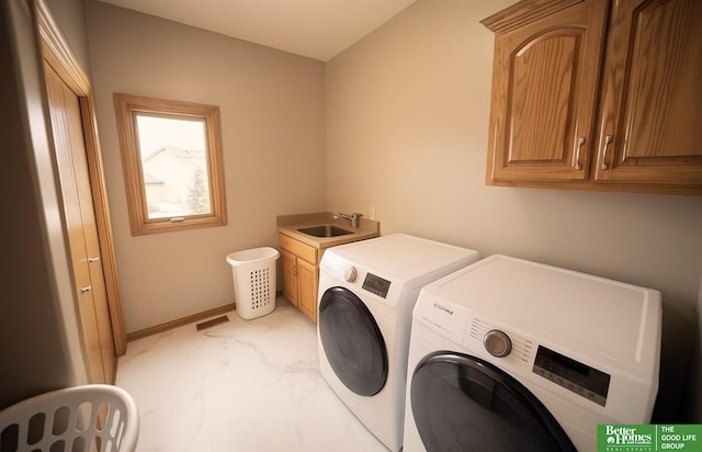 2231 Crystal Creek Dr, Papillion, NE 68046 - laundry area featuring washer and dryer, cabinet space, baseboards, and light marble finish floors