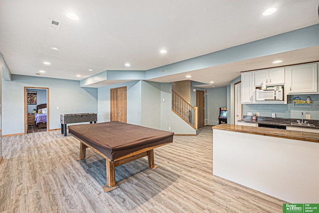 2231 Crystal Creek Dr, Papillion, NE 68046 - game room with billiards, light wood finished floors, wet bar, recessed lighting, and baseboards