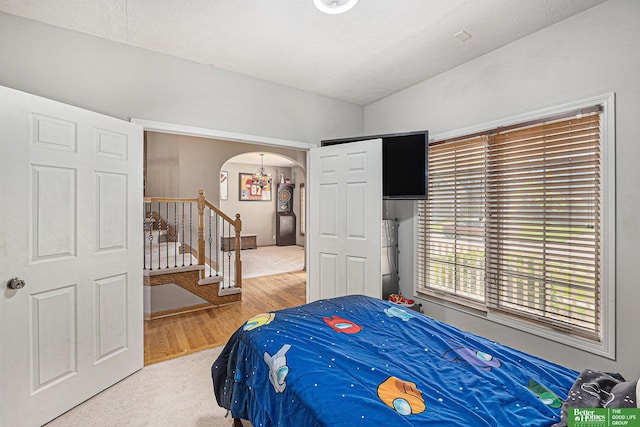 2231 Crystal Creek Dr, Papillion, NE 68046 - bedroom with arched walkways and wood finished floors
