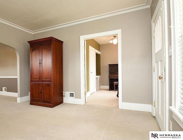4540 S 41st St, Omaha, NE 68107 - spare room with light carpet, arched walkways, crown molding, and baseboards