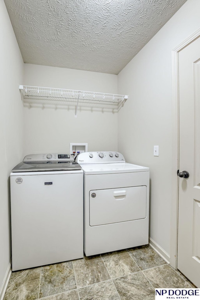 15930 Grebe St, Bennington, NE 68007 - laundry room featuring washing machine and clothes dryer, baseboards, and a textured ceiling
