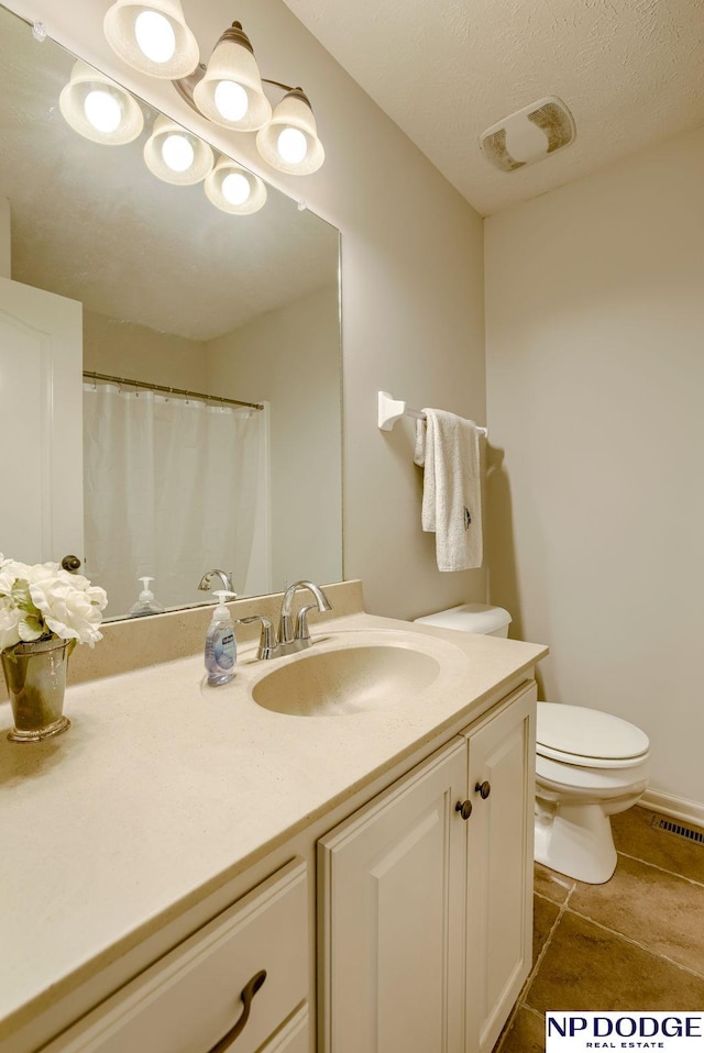 15930 Grebe St, Bennington, NE 68007 - full bathroom with vanity, toilet, and tile patterned floors