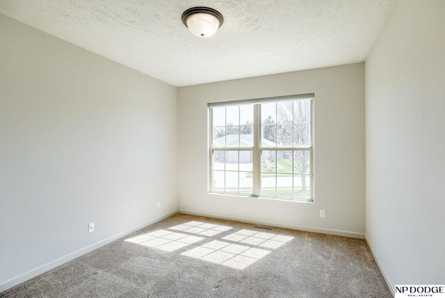 15930 Grebe St, Bennington, NE 68007 - empty room with carpet flooring, baseboards, and a textured ceiling